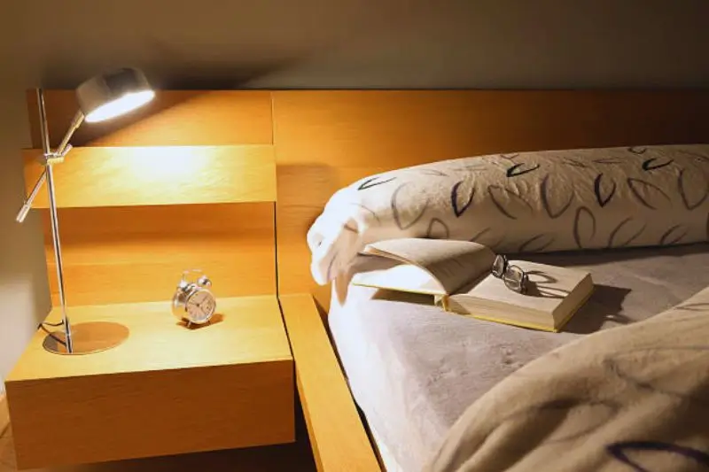 bookcase headboard with cubbies in small mens bedroom