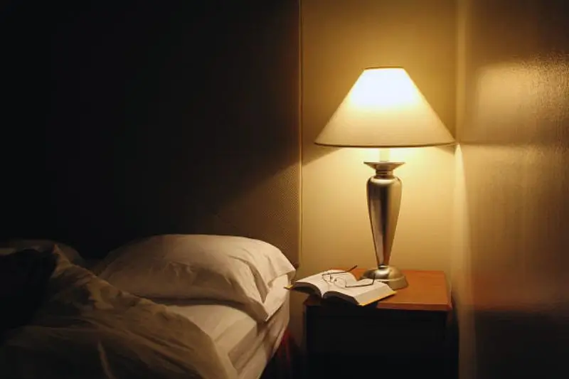 floating shelf nightstand beside bed in small bedroom