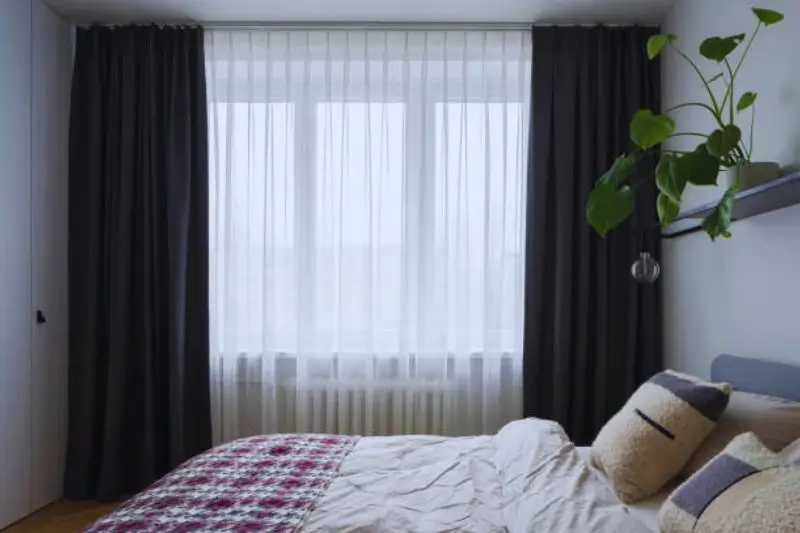 floor length curtains hung high in small mens bedroom