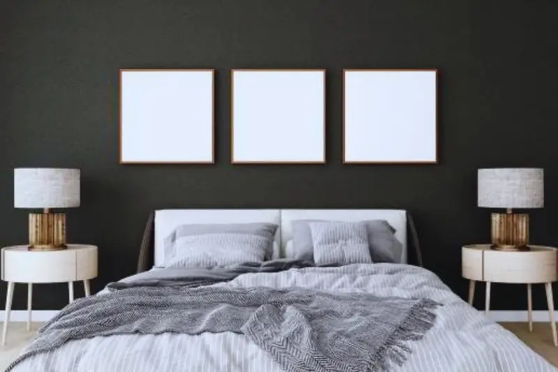 matching black framed gallery wall in small mens bedroom