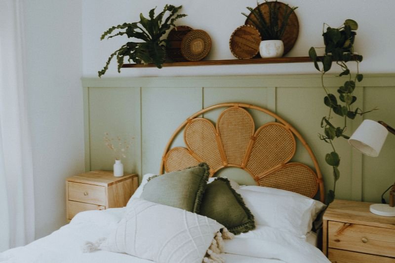 painted arch on wall behind bed in small bedroom