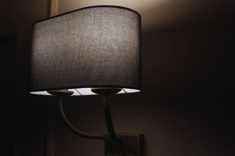 plug in wall sconces above nightstand in small bedroom