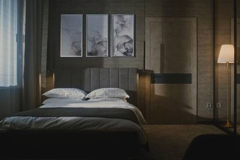 small frames on wall behind door in small bedroom