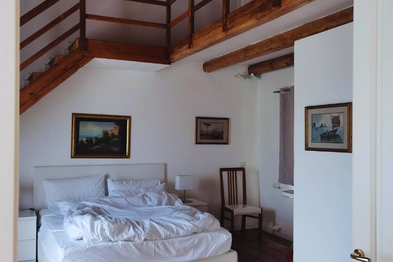 tension rod art rail with hanging prints in small bedroom