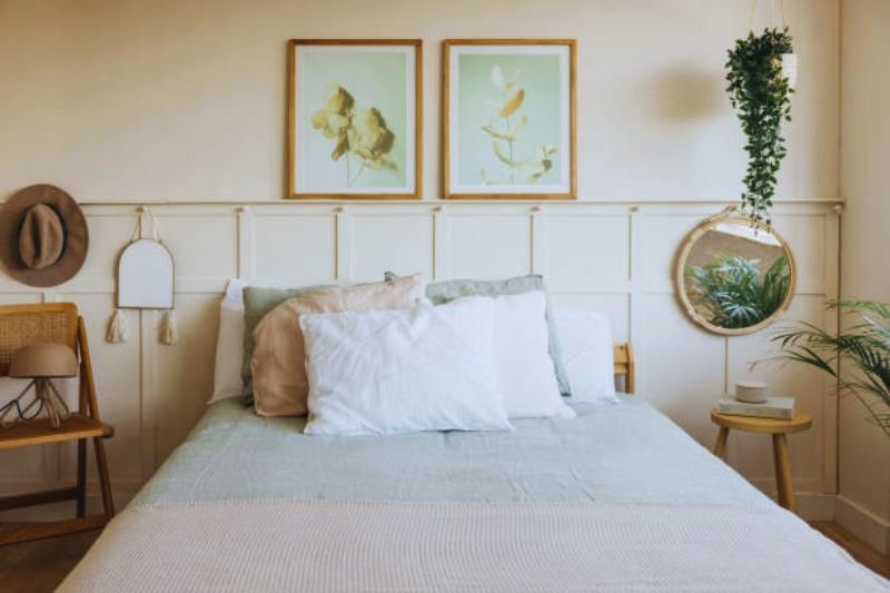 two matching framed prints above headboard in small bedroom