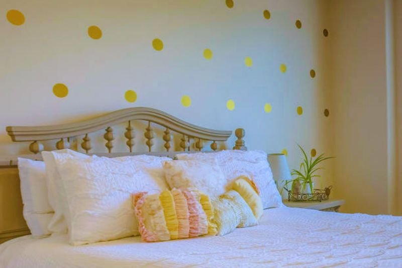 wall decals in arc shape above bed in small bedroom