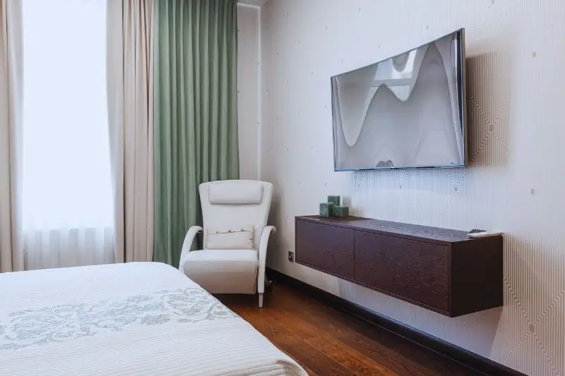 wall mounted TV with no stand in small mens bedroom