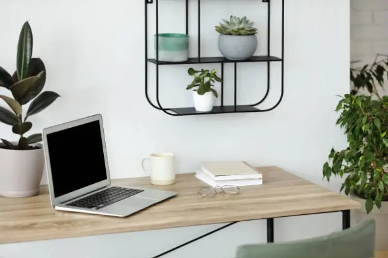 wall mounted floating desk in small mens bedroom