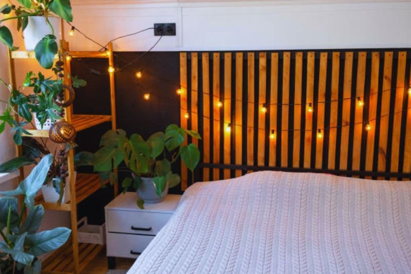 wood slat panel behind bed in small bedroom