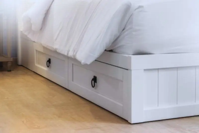 apothecary style small drawer unit at foot of bed