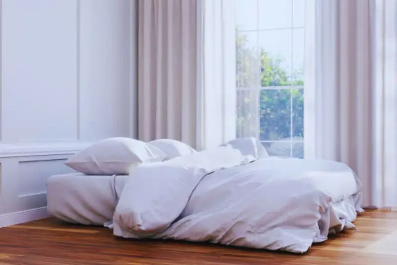 hotel style layered bedding with two duvets in small bedroom