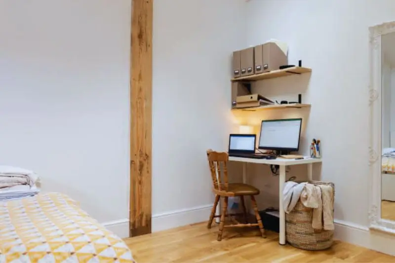 wall mounted fold down desk in small couples bedroom
