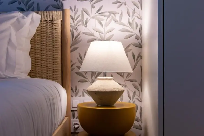 peel and stick textured wallpaper behind bed in small bedroom