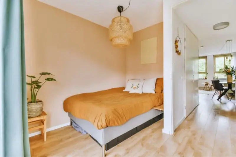 color drenched soft clay walls and ceiling in small bedroom