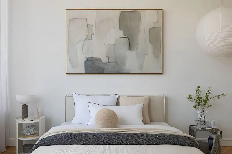 oversized abstract canvas above dresser in small bedroom