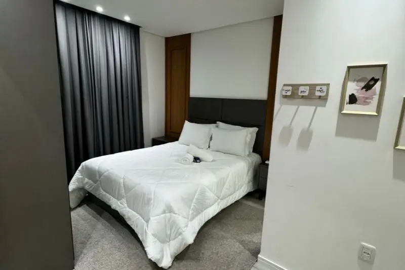 layered rugs under bed in small couples bedroom