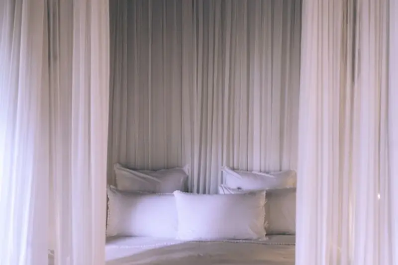 sheer ceiling curtains framing bed as canopy in small bedroom