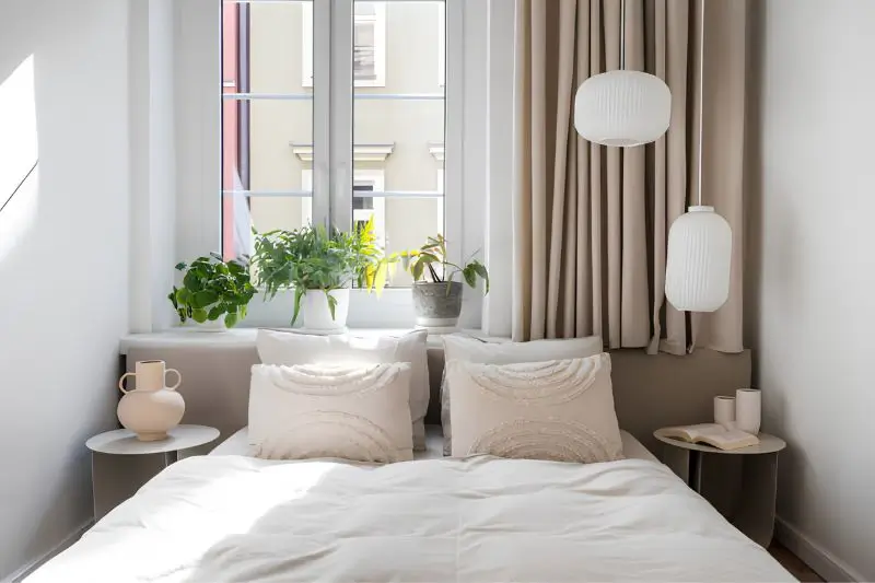 warm greige and cream tones in small couples bedroom