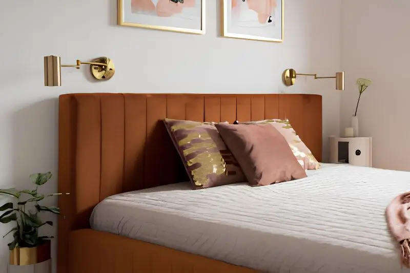 matching brass hardware and sconces in small couples bedroom