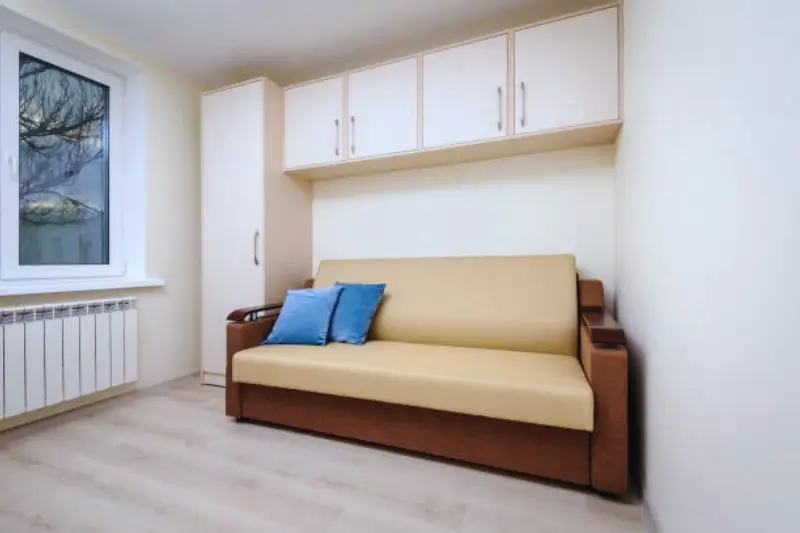 murphy bed folded up revealing open floor in small studio
