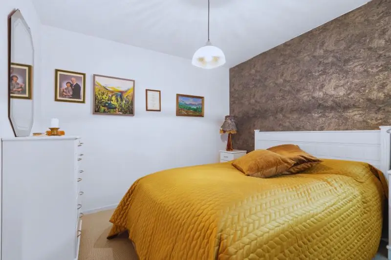 symmetrical lamps and personal photo in small couples bedroom