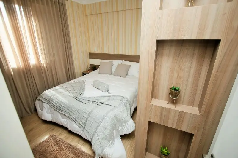 sheer curtain divider separating bedroom in small studio